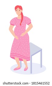 Pregnant red-haired woman or girl in long pink dress stands near stool isolated on a white background. Happy pregnant female. Reception at the gynecologist. Maternity, pregnancy and childbirth