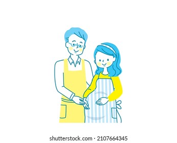 Pregnant smiling woman and husband in apron