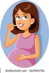 Pregnant Woman Brushing Teeth. Mother to be taking care or her oral hygiene during pregnancy
