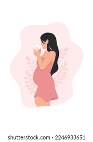 
A pregnant woman drinking milk, side view