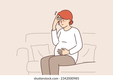 Pregnant woman feeling headache and migraine sitting on couch and waiting for doctor due to prenatal complications. Pregnant girl preparing to become mother needs in vitamins for immunity