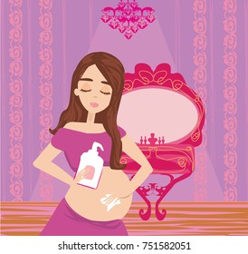Pregnant woman lubricates the stomach remedy against stretch marks 