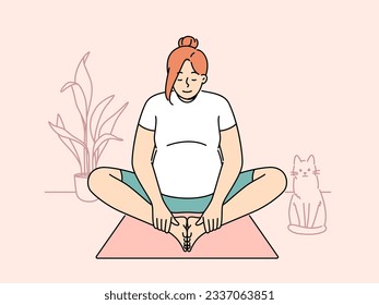 Pregnant woman making morning exercises sitting on fitness mats and getting ready for meditative practices from yoga. Pregnant girl is at home and stretches doing yoga for expectant mothers