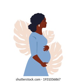 Pregnant woman on a background of leaves.The concept of pregnancy, motherhood, family. Happy mum. Pregnant belly side view. Pregnancy concept. Pregnant woman holds her belly. African american Pregnant