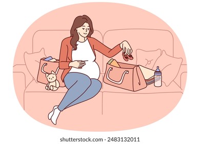 Pregnant woman is packing things for unborn child in bag going to maternity hospital before giving birth. Pregnant girl is sitting on couch getting ready for motherhood and raising baby