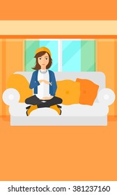 Pregnant woman sitting on sofa.