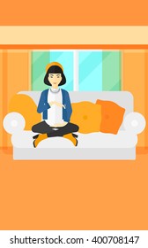 Pregnant woman sitting on sofa.
