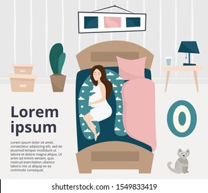 Pregnant woman sleeping on bed on special pillow for pregnant. Spacious bedroom with plant and cat