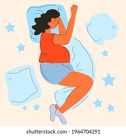 A pregnant woman is sleeping on pillows in her bed.