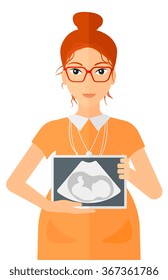 Pregnant woman with ultrasound image.