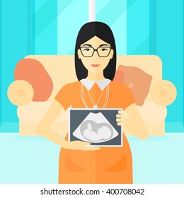 Pregnant woman with ultrasound image.