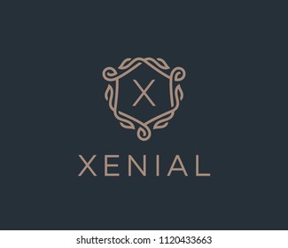 Premium linear shield monogram letter X logotype. Elegant crest leaf stamp icon vector logo. Luxury alphabet frame symbol. 