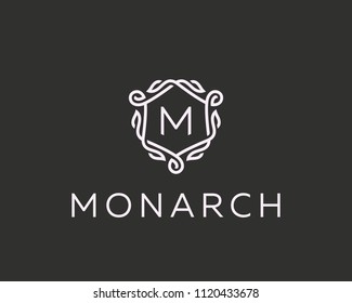 Premium linear shield monogram letter M logotype. Elegant crest leaf stamp icon vector logo. Luxury alphabet frame symbol. 