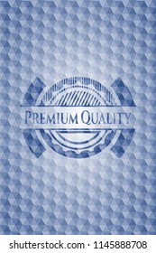 Premium Quality blue badge with geometric pattern background.
