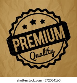 Premium Quality rubber stamp black on a crumpled paper brown background.