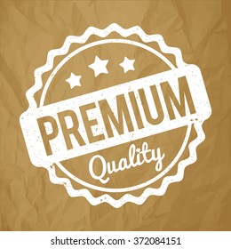 Premium Quality rubber stamp white on a crumpled paper brown background.