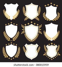 Premium shields and badges set. White shields set with golden laurel wreaths. Vintage design for website, web banner, printed materials. High quality vector illustration isolated on black background