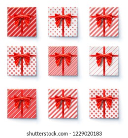 Present boxes with red ribbon and big bow isolated on white background. Top view on gift boxes, festive packaging wrapped in paper with simple different pattern. Set of icons for holidays. Vector.