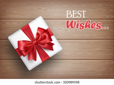 Present Gift Box with Bow on Wooden Background