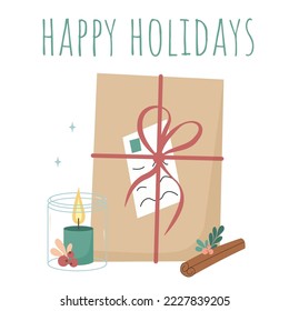 A present wrapped in a craft paper with a red ribbon and letter, standing by the candle in a glass jar and cinnamon stick. Postcard with Happy Holiday lettering