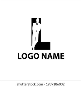 presentable man in a suit is leaning against the letter L negative space