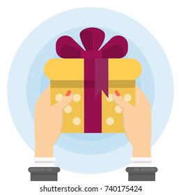 Presenting the gift. Female hands holding gift box with bow and ribbon.