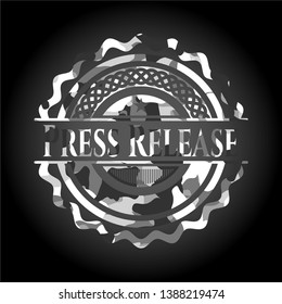 Press Release written on a grey camouflage texture