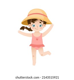 Pretty baby girl in straw hat and swimwear. Adorable child in beachwear. Smiling kid in swimsuit.