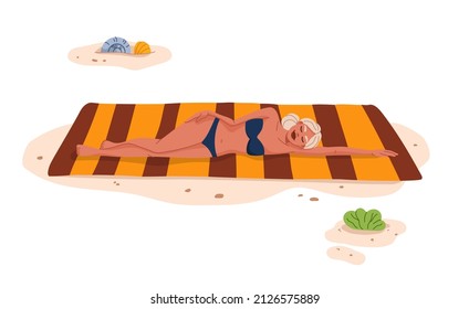 Pretty blonde sunbathing on the beach. Tropical resort leisure, summer vacation travel and holidays leisure. Young woman lying on towel on beach, girl relaxing and sunbathing on hot seacoast sand