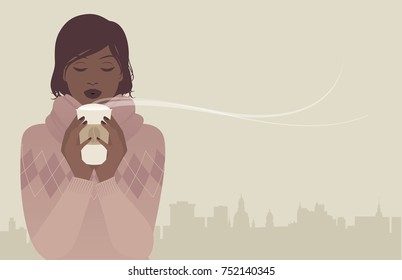 Pretty brunette girl with woolen sweater, drinking a hot coffee on a winter day. City sky line in the background