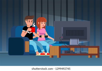 Pretty Couple Watching TV on the Sofa. A Man with a Cup of Hot Coffee, Tea, Chocolate, Cappuccino and a Woman. Sit Resting, Drinking, Eating