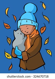 Pretty girl wearing warm hat and scarf holds a grey kitten in her hands