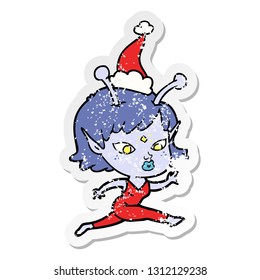 pretty hand drawn distressed sticker cartoon of a alien girl running wearing santa hat
