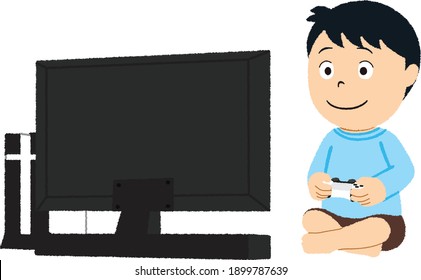Pretty little boy is playing game console and laughing while sitting  at home.
