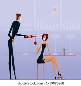 Pretty woman in black dress and a protective mask drinks wine through a straw in a bar during the quarantine period due to covid-19 virus. A gallant waiter in a face mask pours wine into a glass. 