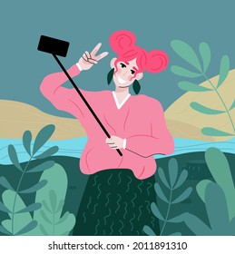 pretty woman takes a selfie on the phone in nature 