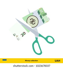 Price or cost reduction concept. Scissors cutting money bill.  hryvnia banknote.