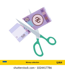 Price or cost reduction concept. Scissors cutting money bill.  hryvnia banknote.