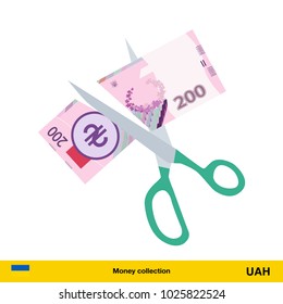 Price or cost reduction concept. Scissors cutting money bill.  hryvnia banknote.