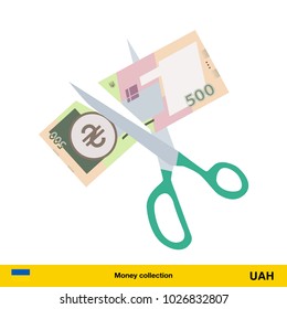 Price or cost reduction concept. Scissors cutting money bill. Hryvnia banknote.