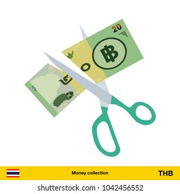 Price or cost reduction concept. Scissors cutting money bill. Thai baht banknote.