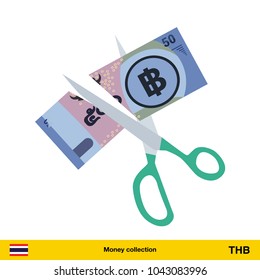 Price or cost reduction concept. Scissors cutting money bill. Thai baht banknote.