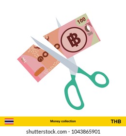 Price or cost reduction concept. Scissors cutting money bill. Thai baht banknote.