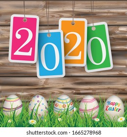 Price stickers with date 2020 on the wooden background with easter eggs in the grass.  Eps 10 vector file.