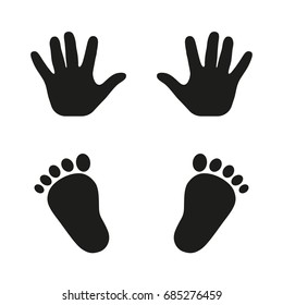 Prints of hands and feet of a child on a white background