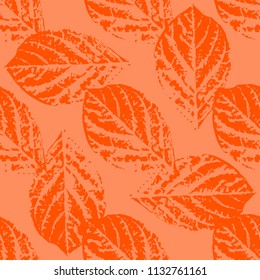 Prints of leaves of trees. Seamless pattern. Orange elements, orange background