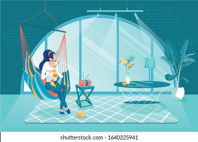 Private Entrepreneur Make Knitted Products at Home. Girl Sitting at Home in Hammock and Knitting. She Makes Fashionable Handmade Souvenirs in Cozy Room with Large Semicircular Window.