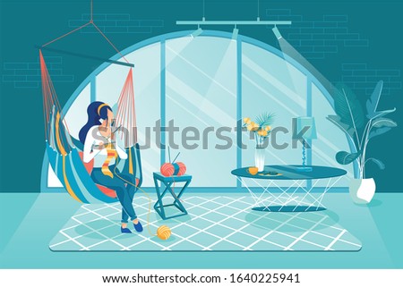 Private Entrepreneur Make Knitted Products at Home. Girl Sitting at Home in Hammock and Knitting. She Makes Fashionable Handmade Souvenirs in Cozy Room with Large Semicircular Window.