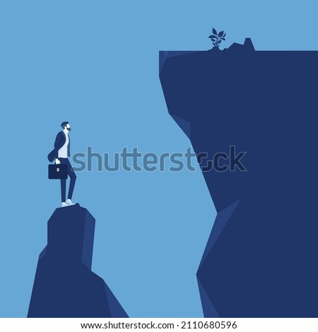 problem and facing challenge concept, Businessman on edge of ravine wondering how to deal with challenging situation
