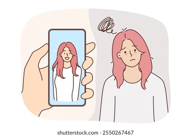 Problem of low self-esteem in upset woman standing near beautiful portrait in mobile phone. Attractive girl is suffering due to low self-esteem and feels tired or ugly becase of psychological problems